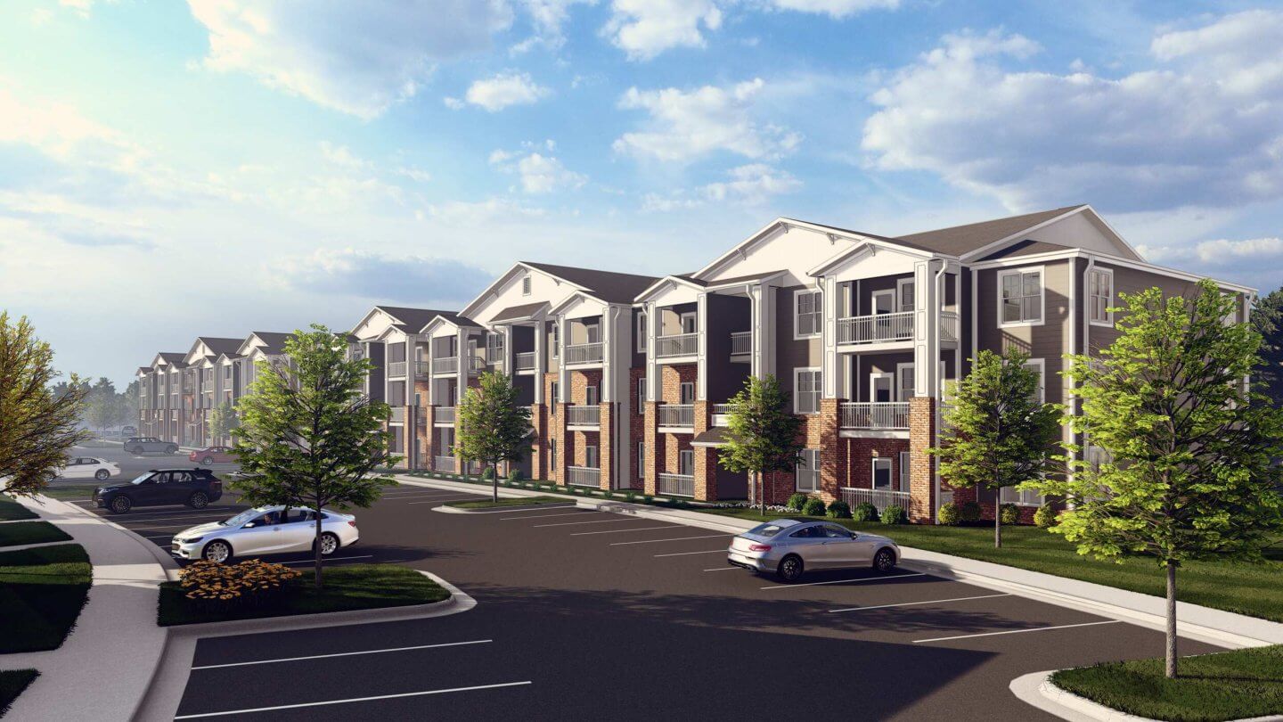 Modern apartment building rising above a landscaped drive and parked cars at Ivory on Long Creek in Gastonia, NC.