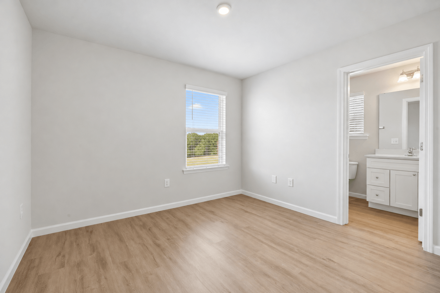 bright minimal bedroom with ensuite